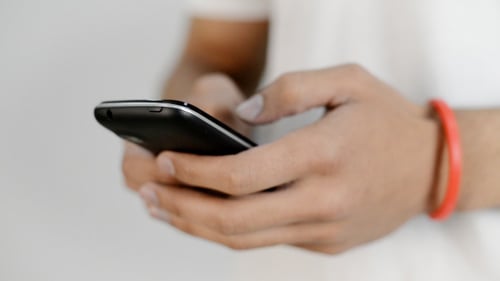 Young Adult Using Smartphone Technology Indoors