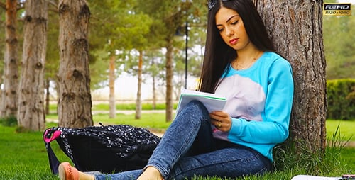 Young Woman Studying Outdoors Under Tree