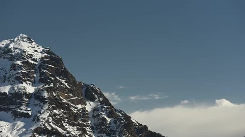 View of jagged mountain peak against blue sky