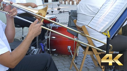 Musicians Playing Trombone and Drums Outdoor Performance