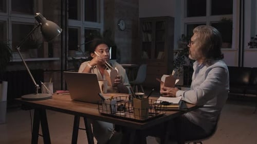 Colleagues Eating Takeout and Discussing at Work