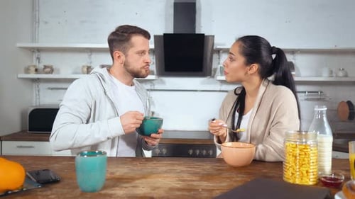 Couple Enjoying Breakfast Together in a Bright Kitchen