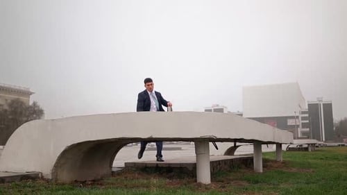 Successful Businessman in Suit Rush To Work and Jumps Over an Obstacle. Parkour