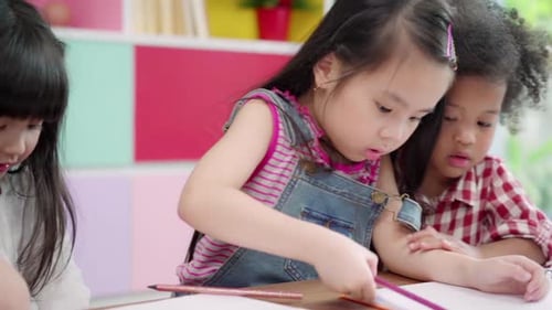 Children Drawing With Colored Pencils in Class