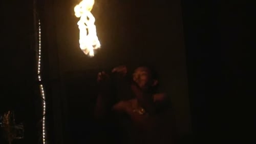 Man Blows Fire From Mouth in the Darkness