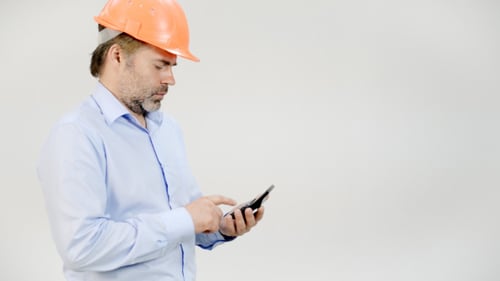 Construction Worker Using Calculator on White Background