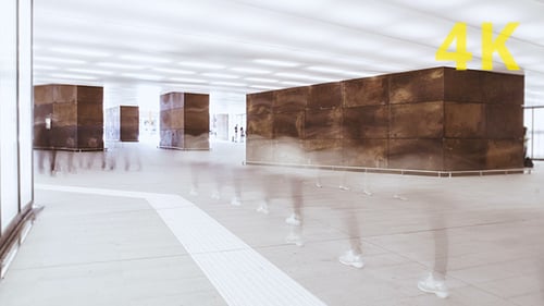 Interior Space with Bronze Structures and Moving People
