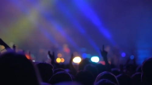 Silhouetted Crowd Enjoying a Concert With Bright Lights