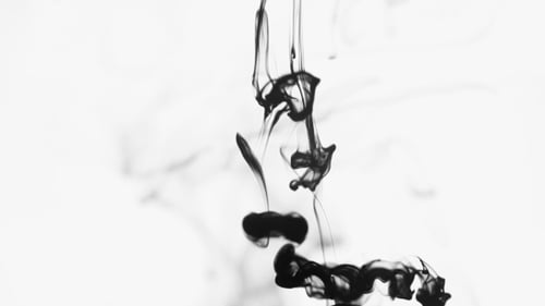 Organic Black Ink Drops Creating Abstract Fluid Patterns