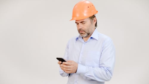 Engineer Typing on Phone