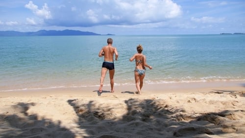 Happy Couple Running On The Beach In The Sea