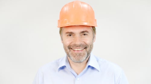 Man Wearing Hardhat Smiling at Camera