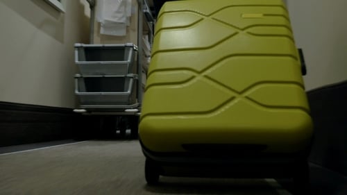 Rolling Trolley Bag In Hotel Corridor
