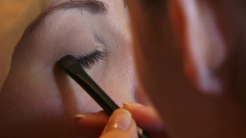 Woman Applying Eye Makeup with Liner Brush