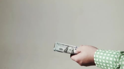 Business People Exchange Money and Shake Hands