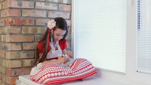 Girl Sitting with Flower by Window