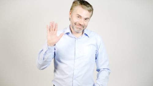 Man Smiling and Waving Hello