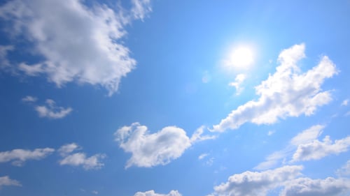 White Clouds Float Across a Blue Sky