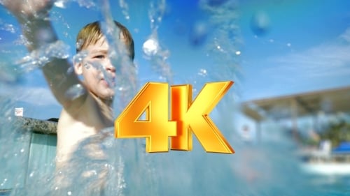 Happy Child In Swimming Pool Splashing Water