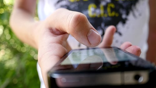 Person Typing on a Smartphone Close Up Outdoors