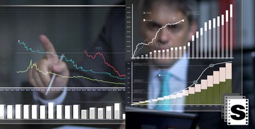 Financial Analyst Examining Graphs on Transparent Screen