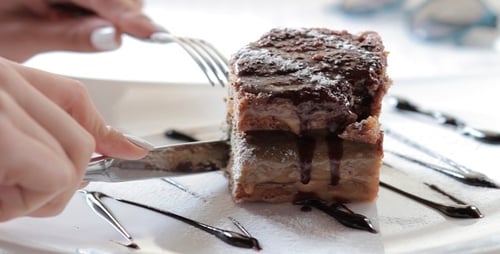 The Girl Eats A Sweet Cake In Restaurant