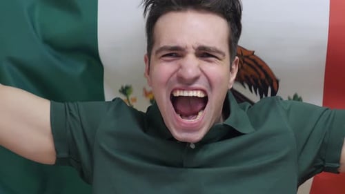 Excited Man Yelling in Front of Flag