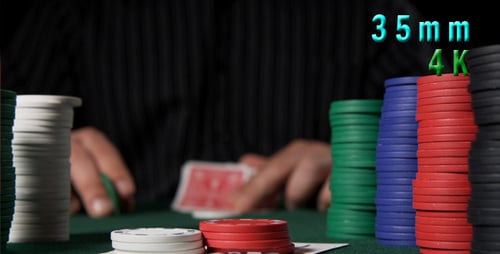 Poker Player Betting Chips at Casino Table