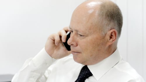 Adult Man Talking on Smartphone in Office