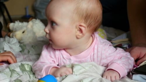 Infant Lying on Stomach on Blanket