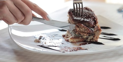 Woman Eats The Sweet Cake In Restaurant