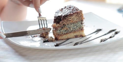 The Girl Eats A Sweet Cake In Restaurant