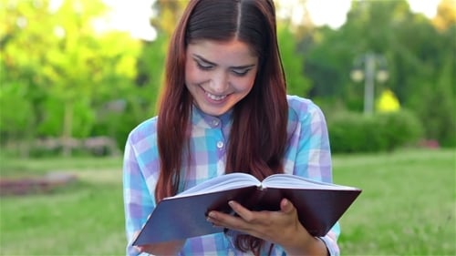 Beautiful Girl With Book In The Park