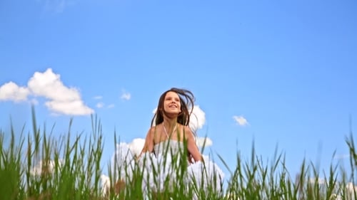 Happy Girl Jumping In Green Field