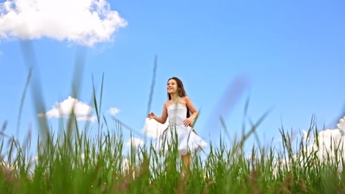 Happy Girl Jumping In Green Meadow