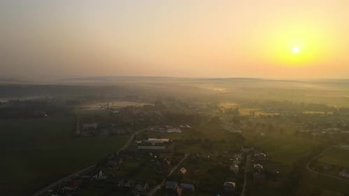 Aerial View Foggy Sunrise Over Residential Houses in Suburban Rural Area