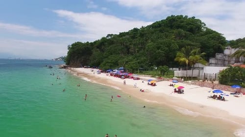Tropical Beach with Turquoise Water and Relaxing People