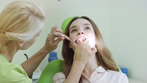 Young Woman Having Teeth Examination at Dentist. Professional Oral Checkup