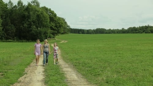 Girls Walking Together on Dirt Path in Field