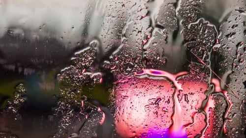 Drops Of Rain Flowing On Car Glass