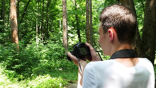 Teen In Wilderness Area Taking Picture