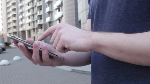 Young Adult Using Mobile Phone in Urban Setting