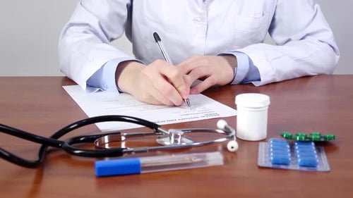 Doctor Writing a Medical History and Screening Form of the Patient, Front View