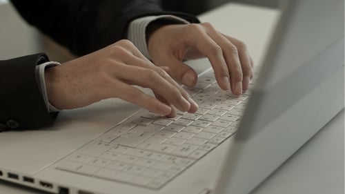 Person Typing on a Laptop Keyboard at Work
