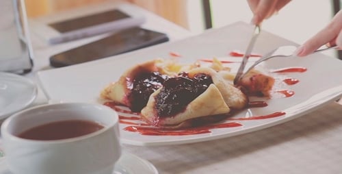 The Girl Eats A Dessert In A Restaurant