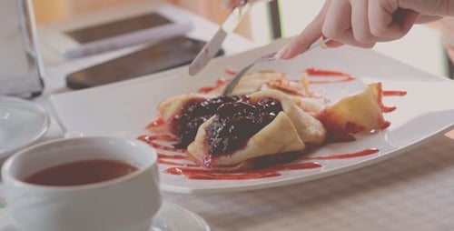 The Girl Eats A Dessert In A Restaurant