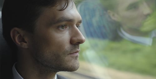 Young Man Gazing Out Window During Daytime