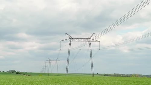 Moving Through Electric High Voltage Pylon Against Beautiful Sky