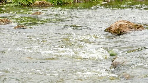 Fast Flowing River With Stones In The Water Slow