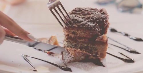 Woman Eating Cake In Restaurant